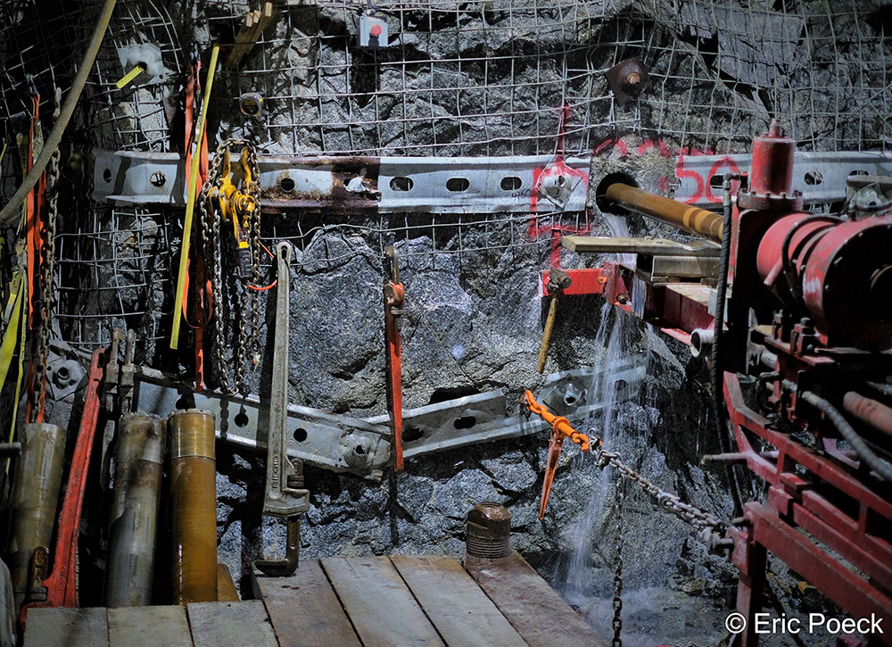 Honorable mention photo by Eric Poeck: Close-up of a mining drill rig drilling into a stone wall