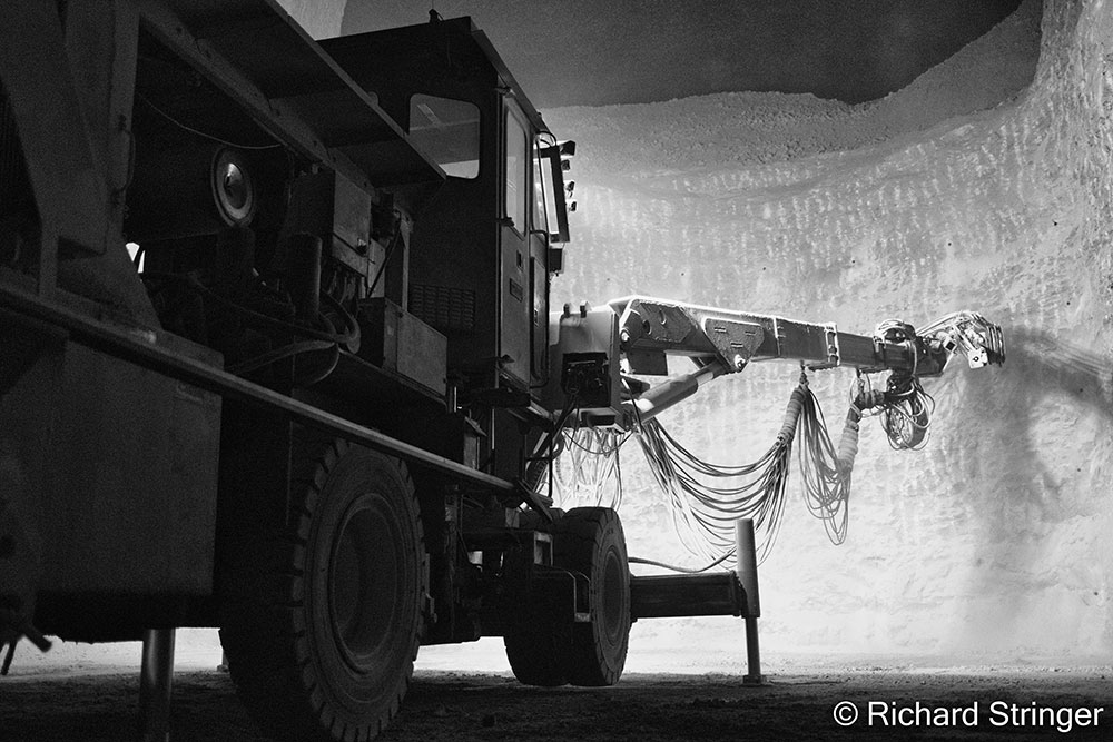 Honorable mention photo by Richard Stringer: Black and white photo of a double boom jumbo drilling a bench